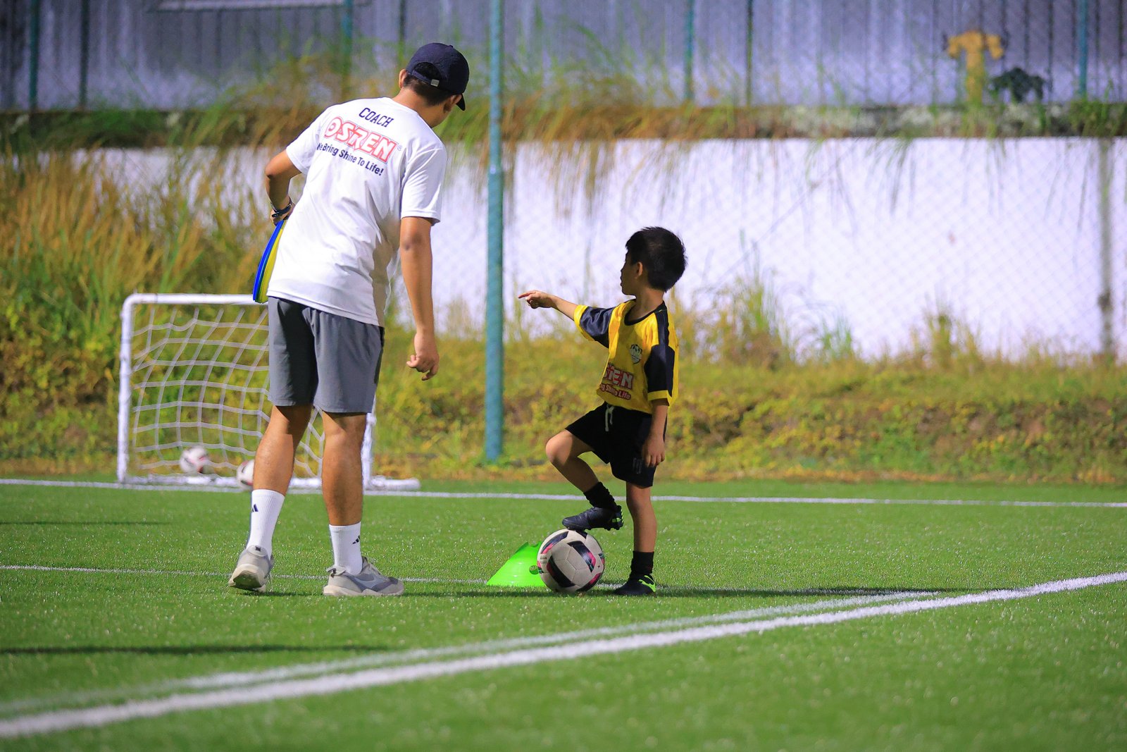 Coach instructing young player