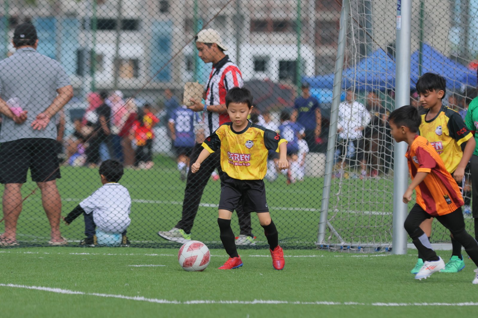 Young player dribbling during match